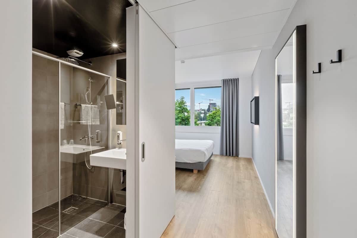 Premium bedding, laptop workspace, blackout drapes, soundproofing