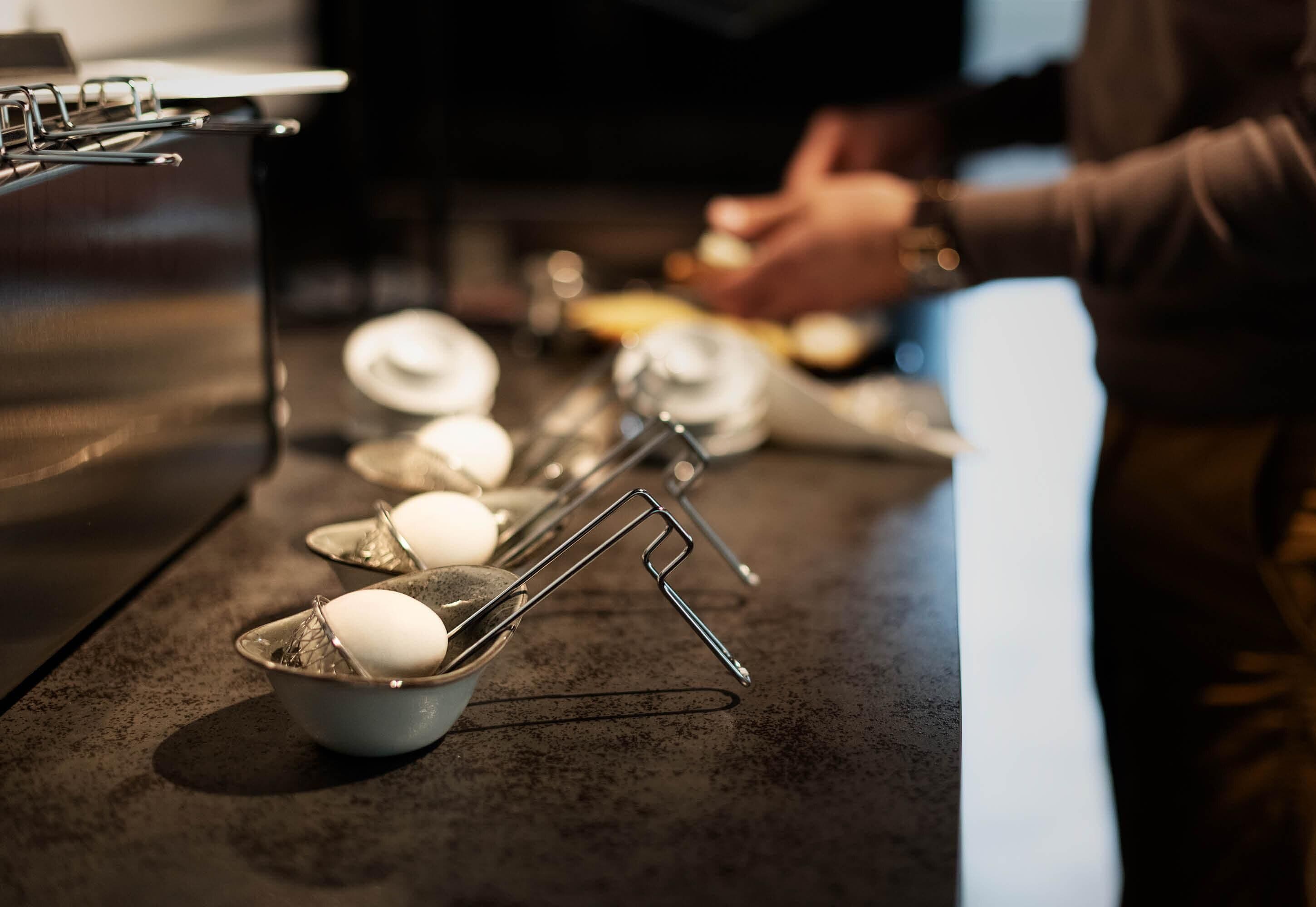 A kitchen counter with a coffee machine and a person preparing coffee.