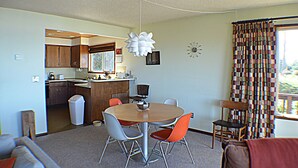 A compact living space with a kitchen, dining area, and a small seating area. - Sea it All - Ocean View Yachats (Yachats)