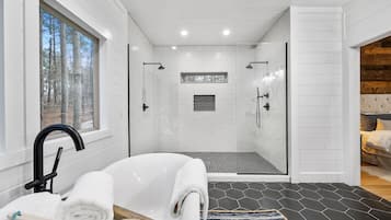 Bathtub, hair dryer, towels, shampoo