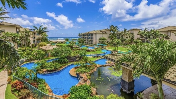 A resort with multiple swimming pools, lush greenery, and beachfront views. - 2 Bedroom 3 bath in Waipouli Deluxe oceanfront condominium Resort (Kapaa)