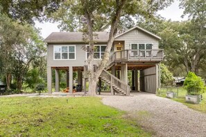 Stroll up to this charming two-story home, surrounded by a lush lawn and trees, and enjoy the peaceful atmosphere from the covered porch or second-floor balcony.