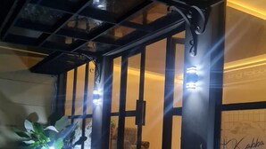 A modern building with a glass facade, illuminated by exterior lights. - KingKabba Guest House Wonosobo (Wonosobo)