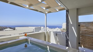 A rooftop pool with a clear view of the sea and distant buildings.