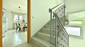 A staircase with a metal railing leading to an upper floor. - Holiday home with a pool for 7 persons only 6 km from beautiful beaches. (Porec)