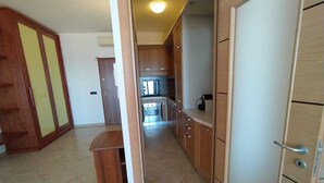 A kitchen with wooden cabinets, a countertop, and a stove. - Rosa Virginia vista mare (Gallipoli)