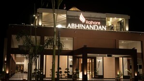 A modern hotel with a prominent sign reading "Rajhans Abhinandan." - Hotel Rajhans Abhinandan (Bhopal)