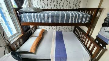 A bunk bed with striped bedding, a pillow, and a blanket.