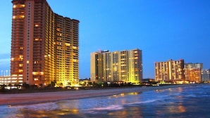 A beachfront hotel with multiple high-rise buildings, a sandy beach, and a calm sea. - Royale Palms 1201 2 Br Oceanfront in Kingston,Pool (Myrtle Beach)