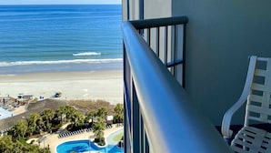 A balcony with a view of the ocean and a pool area. - Royale Palms 1201H Oceanview Studio in Kingston (Myrtle Beach)