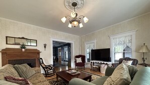 A spacious living room with a fireplace, a television, and comfortable seating.