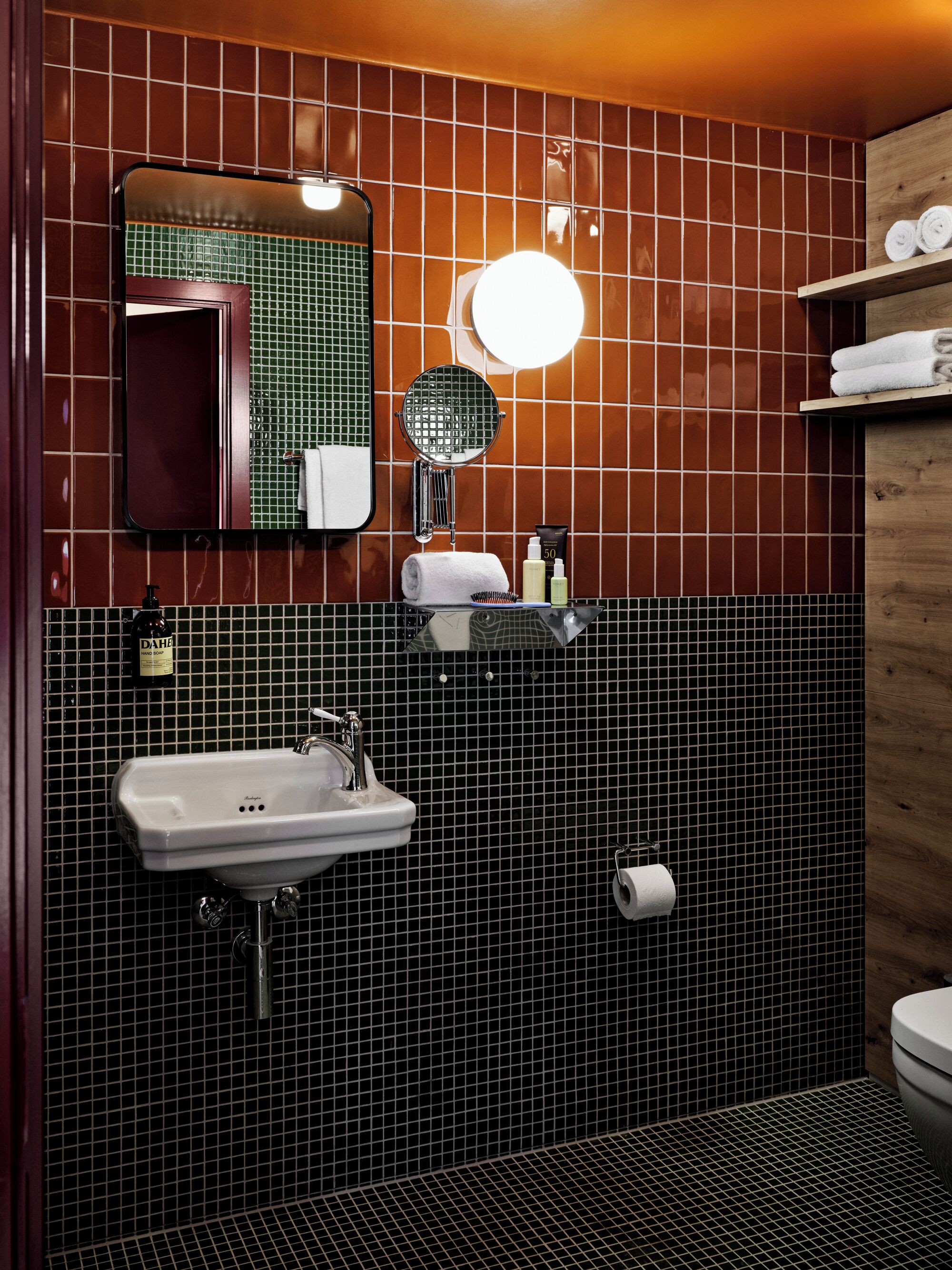 A bathroom with a sink, mirror, and towel rack.