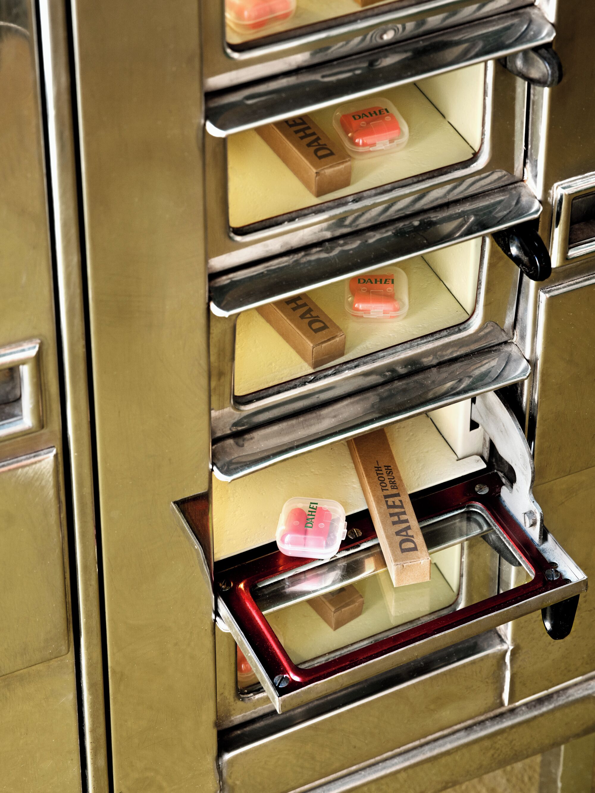 A vintage elevator with a brass finish and a mirrored interior.