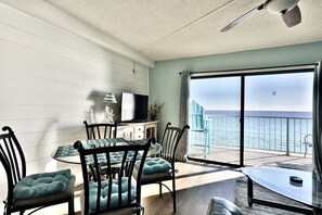 Enjoy a room with a balcony offering a sea view, a round table, and a television.