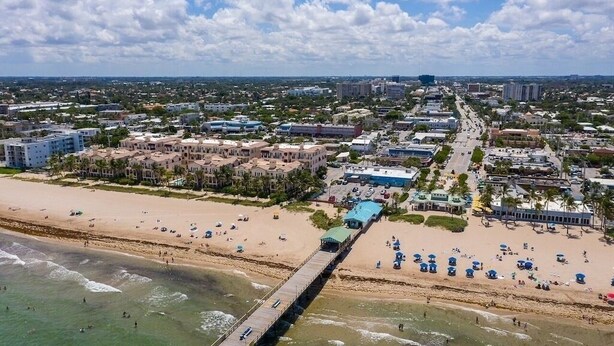 A coastal cityscape with a beach, a pier, and various buildings. - Tropical Paradise Beach Getaway, Villa #4 (Lauderdale-by-the-Sea)
