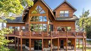 A large wooden house with a spacious deck and multiple balconies. - Fischer's Paradise (Presque Isle)