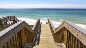 A wooden boardwalk leading to a beach with clear blue water and a sandy shore. - Stylish 1BR Condo w/ Bay View! Balcony, Pool, Tiki Bar, Tram to Beach & Wharf (Miramar Beach)