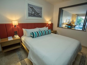 Relax in this inviting space with a large bed, two nightstands, and a stunning view.