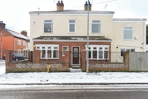A two-story residential building with a brick facade, a gated entrance, and a visible garage door. - Thy Grace 3 Bedroom 2 Shower Room Central Newland (Kingston upon Hull)