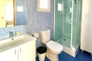 Bathroom features a sink, toilet, and shower.