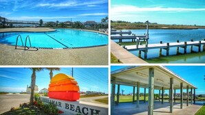 A swimming pool, a dock over water, a colorful beach sign, and a covered pavilion.