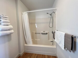 Essentials - Single Queen, Handicapped Accessible | Bathroom | Combined shower/tub, towels, soap, shampoo - Island Pond Country Inn (Formerly the Lakefront Inn & Motel) (Brighton)