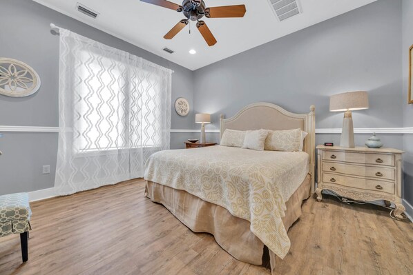 A bedroom with a bed, bedside tables, a ceiling fan, and a window with curtains. - 🦩That's What Sea Shed! Sandestin Golf and Beach Resort ~ Golf Cart Included🦩 (Destin)