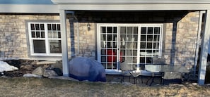 Relax in a sheltered outdoor space with a table and chairs.