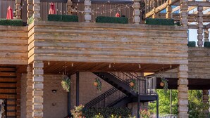 A wooden structure with a balcony, hanging plants, and a staircase. - H18 ~ Large Condo w/ Private Rooftop with Downtown Views ~ Garage Parking ~ 9 Minute to Broadway (Nashville)