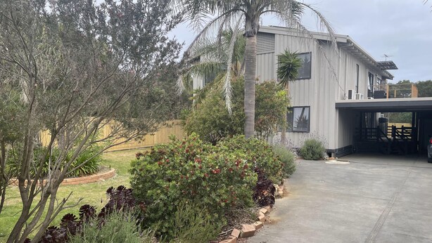 A modern two-story house with a covered garage and a landscaped garden. - Spacious ocean view beach house - sleeps 12 (Smiths Beach)