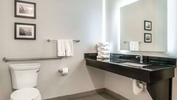 A modern bathroom with a toilet, sink, and towel rack.