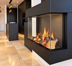 A modern interior with a built-in fireplace, a marble accent piece, and a clean, minimalist design. - Magnificent villa in Orihuela Costa close to everything with heated pool* (Orihuela)