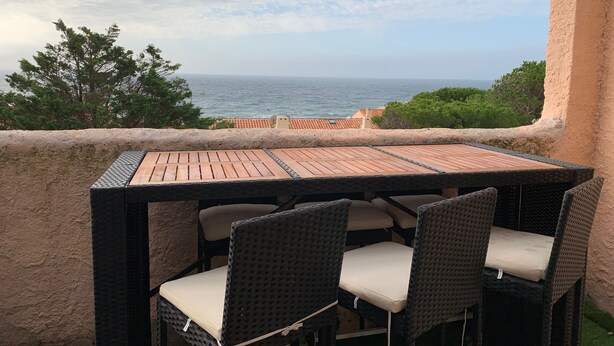 A balcony with a table and chairs overlooking the sea. - MAGNIFICENT SEA VIEW 🌊  (Sausset-les-Pins)