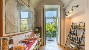 A corridor with a breakfast bar, breakfast items, a wine rack, and a view of the outdoors. - THE BELLINI HOUSE (Naples)