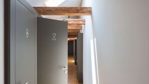 A hallway with a wooden ceiling and a door with a lock and a keyhole. - Atik Rooms (Ljubljana)
