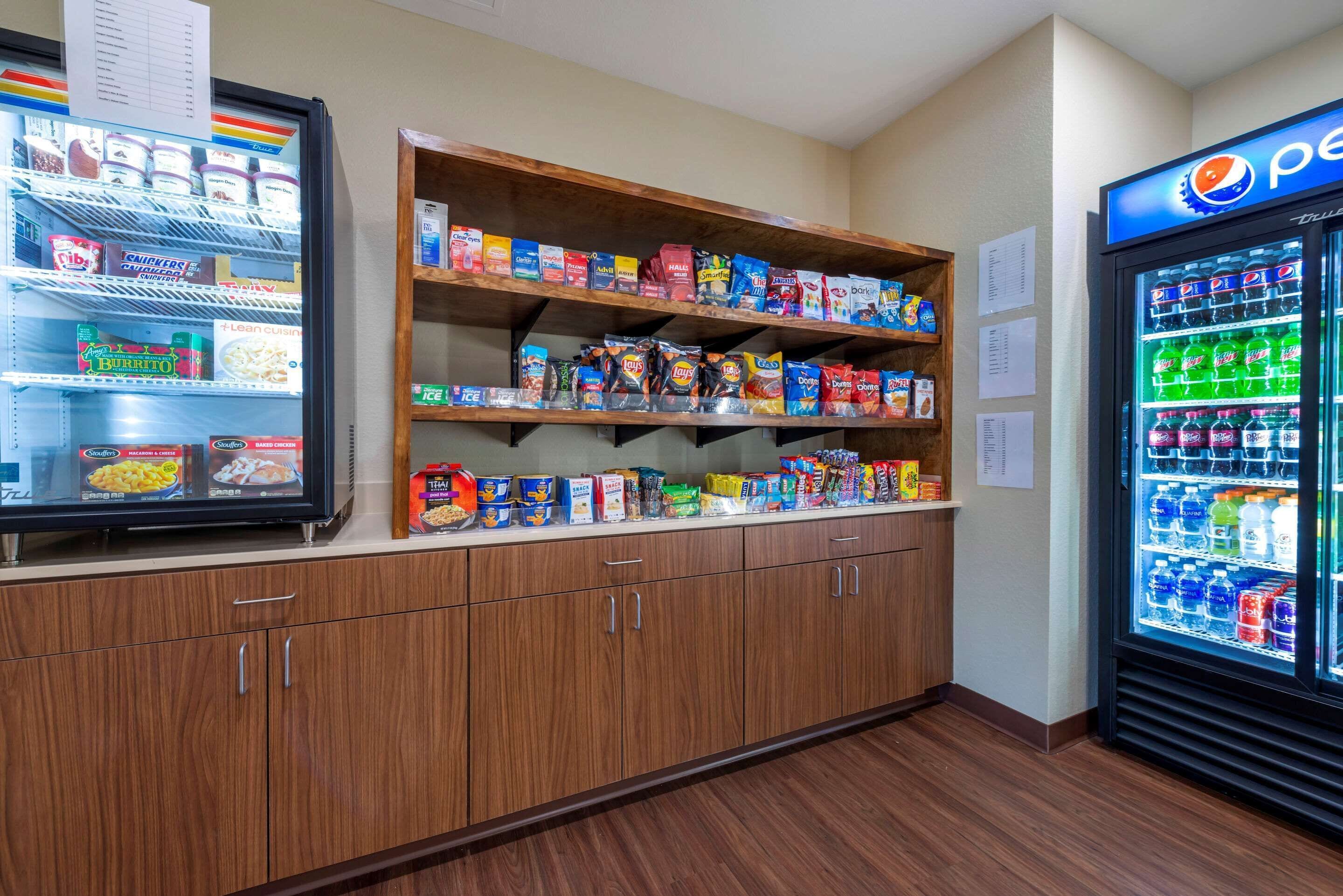 A vending machine area with snacks and drinks, including a Pepsi cooler.