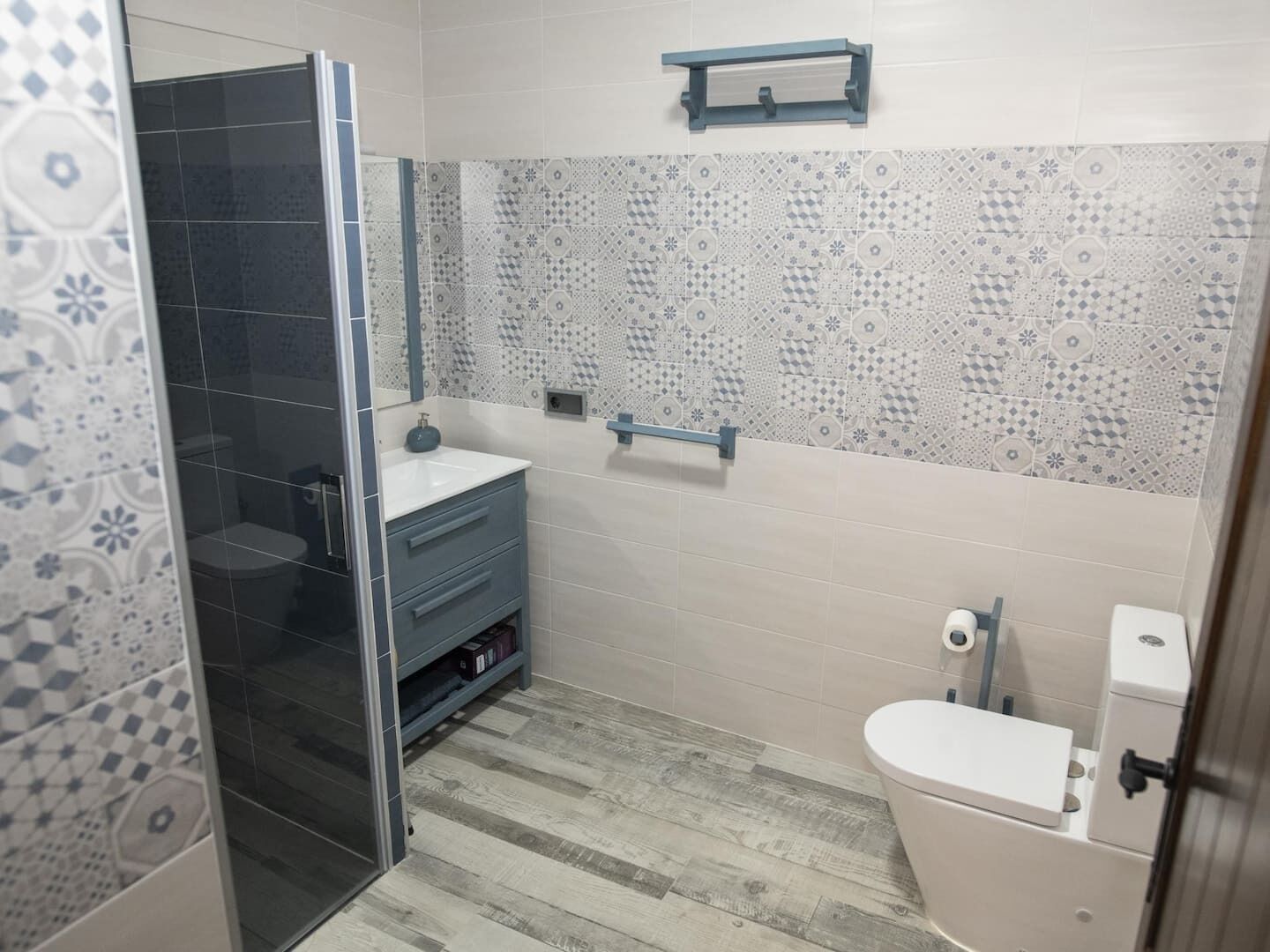 A bathroom with a shower, toilet, and sink.