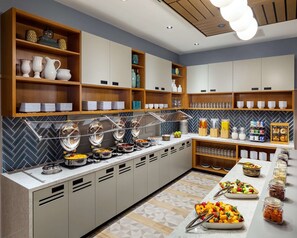 A buffet setup with various food stations, including a fruit display and a beverage area. - Hyatt Place Harrisonburg (Harrisonburg)