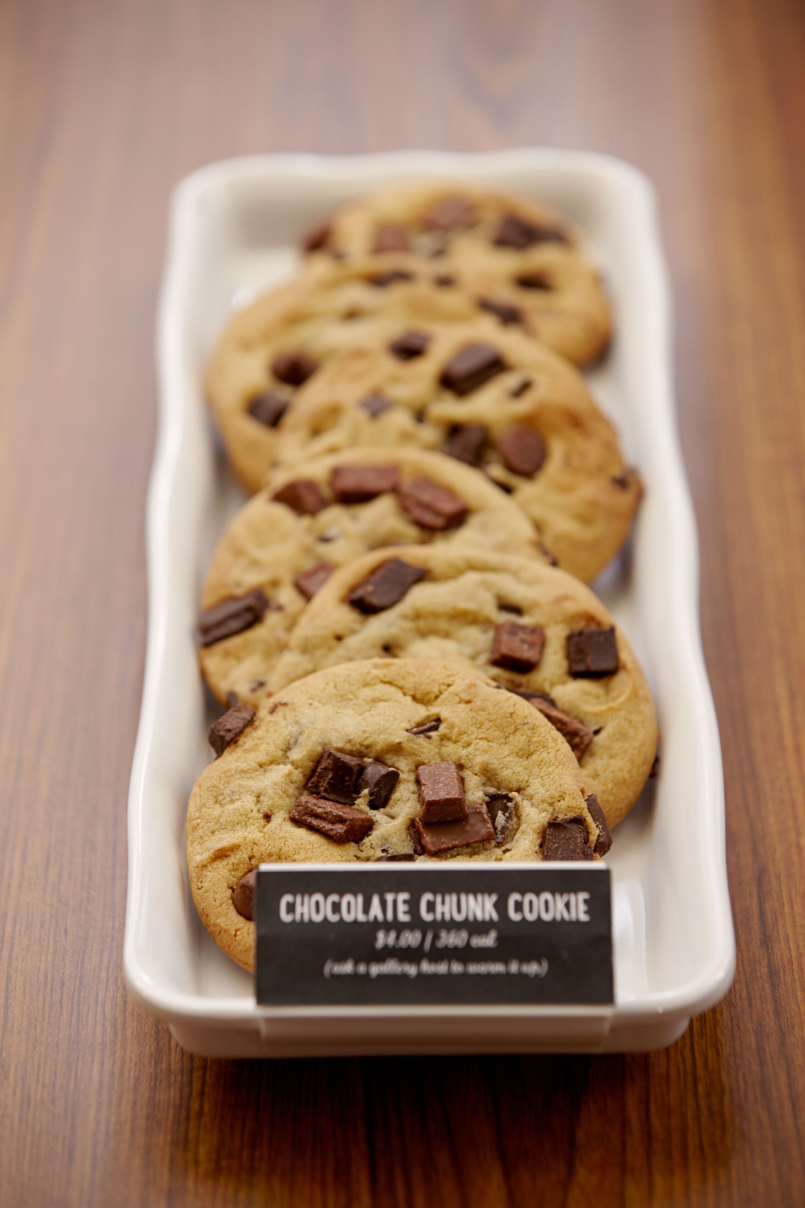 A tray of chocolate chunk cookies with a label.