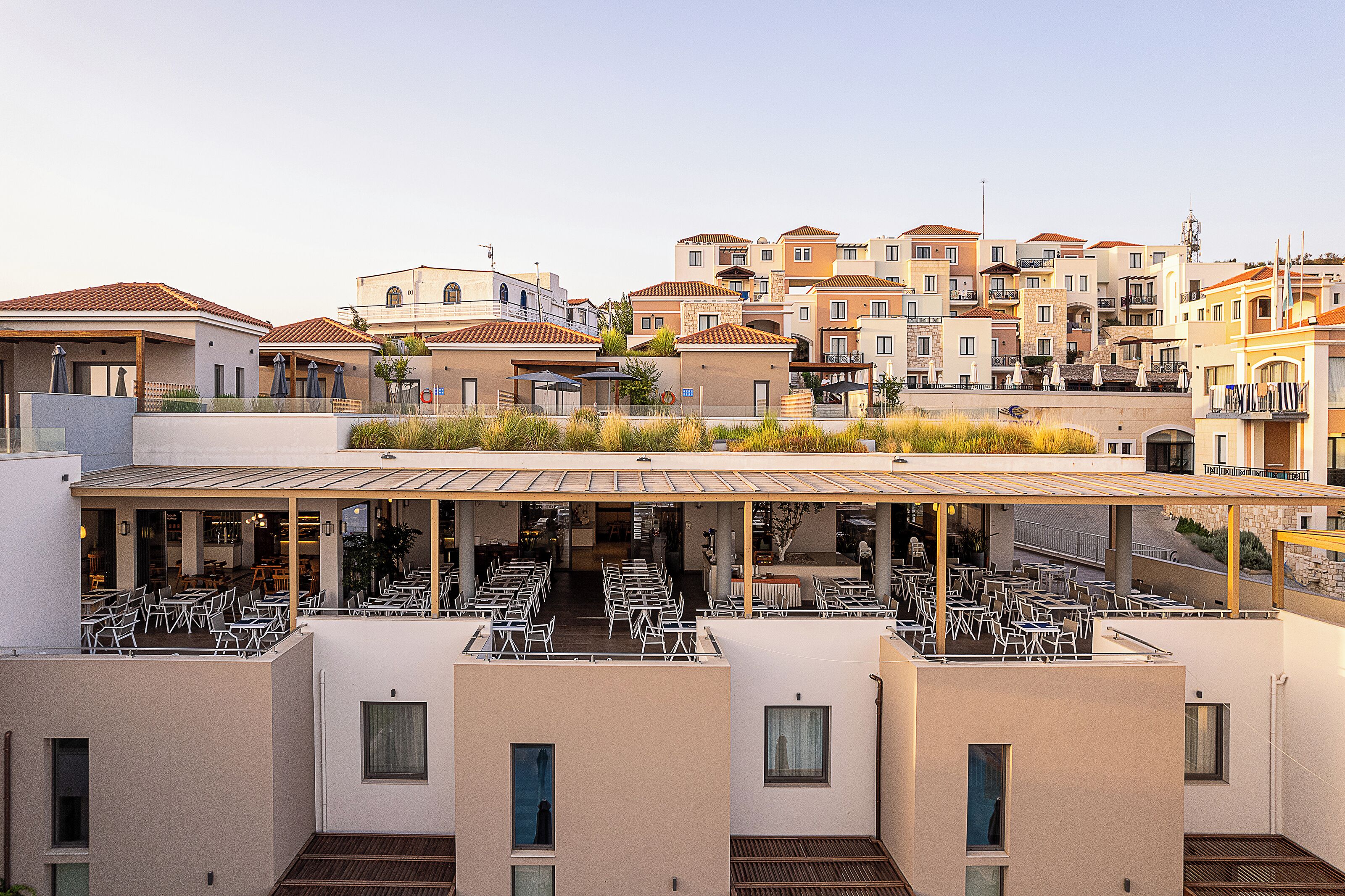 A rooftop terrace with outdoor seating and a view of the surrounding buildings.