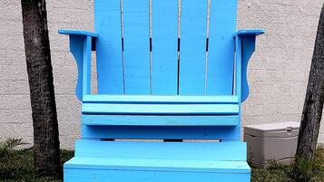A blue Adirondack chair with a sign that reads "Top of the Gulf."
