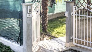 A gated entrance with a concrete pillar, a metal gate, and a number '51' sign. - M273 - Marcelli, new three-room apartment with garden (Marcelli)