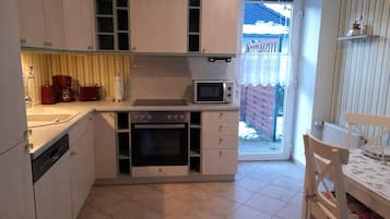 Fridge, stovetop, dishwasher, coffee/tea maker