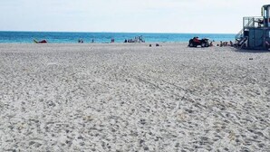 A beach with a lifeguard tower, sandy beach, and ocean. - 175sqm High-end Luxury Apartment - Heart of CPH (Copenhagen)