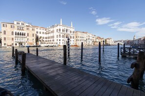 A wooden dock extending into calm water with buildings in the background. - Fortuny 3967 Luxury Suites Wine - Ve-l736-sanm3967at (Venice)