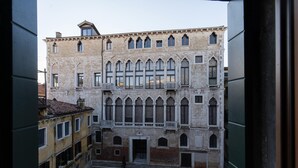 A courtyard with a building featuring arched windows and balconies, surrounded by other structures. - Fortuny 3967 Luxury Suites Wine - Ve-l736-sanm3967at (Venice)