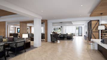 A spacious living area with a herringbone floor, a dining area with a herringbone pattern, and a kitchen with wooden accents.