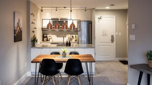 A modern kitchen with a central island, stainless steel appliances, and pendant lighting. - ❄️ Whistler Center 1BR:Walk Everywhere. Free Parking. Fire, Sleeps 4 ❄️ (Whistler)