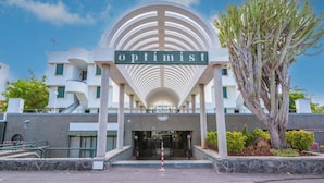 A building with a large arched entrance labeled "Optimist."
