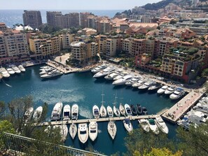 A marina with numerous yachts docked, surrounded by residential buildings and a view of the sea. - Provençal Villa with Large Pool • 9000 m² of Nature • Total Privacy (Draguignan)